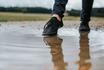 schwarze Schuhe und Pfütze