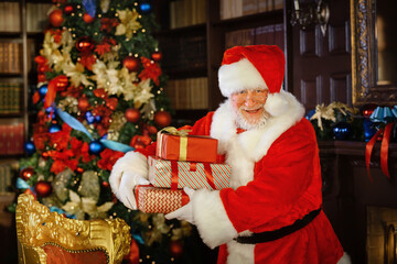 Santa Claus is getting ready for Christmas, he is packing children's gifts. Christmas decoration.