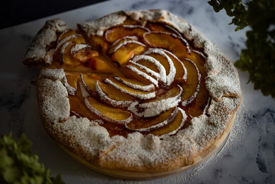 Galette with nectarines and thyme on the table
