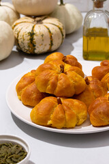 pumpkin buns on white table