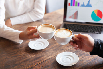 Two businessmen talking in a board room about joint business and summarize the company's profits with a graph showing successful performance. A colleague reviewed the results of the quarterly report.