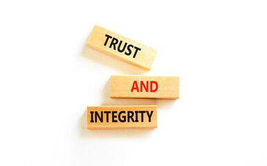 Trust and integrity symbol. Concept words Trust and integrity on wooden blocks. Beautiful white...