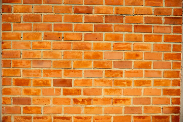 Obraz premium Orange exposed brick wall background