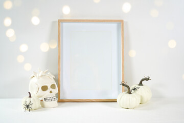 Halloween product mockup. Wall art picture frame mockup with white skull pumpkins against a white...