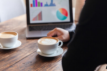 Two businessmen talking in a board room about joint business and summarize the company's profits with a graph showing successful performance. A colleague reviewed the results of the quarterly report.