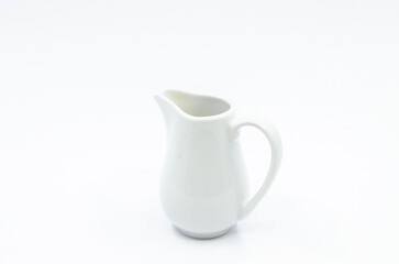 Small milk pot. Porcelain milk pot isolated on a white background.
