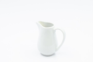 Small milk pot. Porcelain milk pot isolated on a white background.
