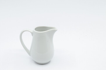 Small milk pot. Porcelain milk pot isolated on a white background.
