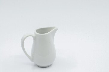 Small milk pot. Porcelain milk pot isolated on a white background.
