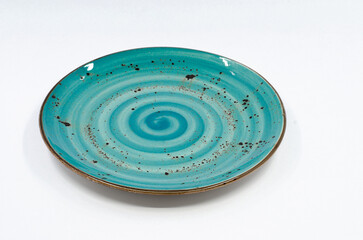 Fototapeta na wymiar Blue porcelain plate. Blue colored porcelain plate isolated on white background. 