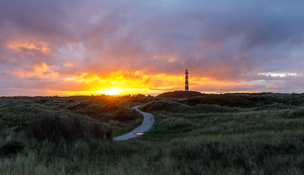 Sunset on island with lighthouse. Ameland Hollum