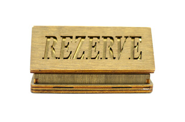 Table reservation letter. On isolated background
desktop wooden reservation sign.