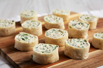 Homemade Pinwheel Tortilla Appetizers with Bacon, Spinach, Green Onion and Cream Cheese, side view.