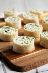 Homemade Pinwheel Tortilla Appetizers with Bacon, Spinach, Green Onion and Cream Cheese, side view.