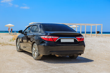 Car on a sandy beach by the sea