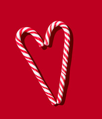 Candy cane heart on red pastel background