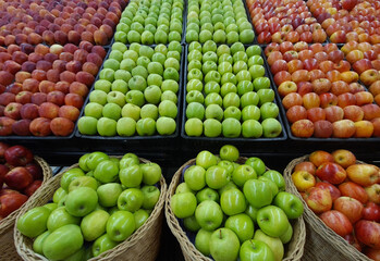 Red and green apples in shop racks