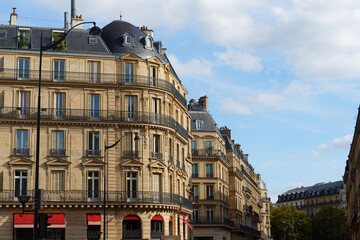 Naklejka premium The facades of traditional French houses with typical balconies and windows. Paris.