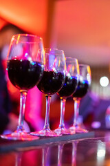 Row of red wine glasses on the counter