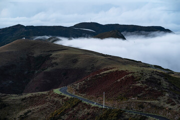 Beautiful panoramic view of the mountain landscape filled with clouds, seen from a hill near Rabaçal, Madeira