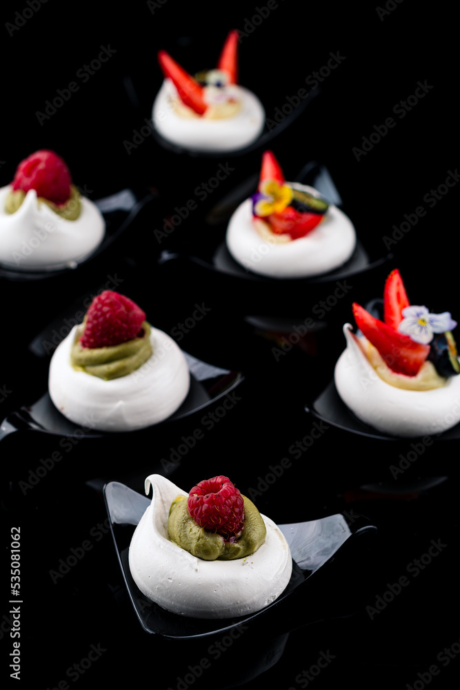 Canvas Prints Sweet meringue cake with fresh raspberries On a black background