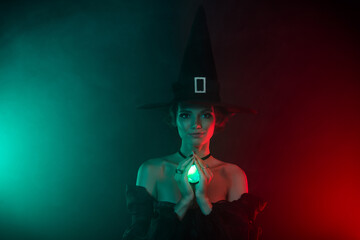 Photo of lady warlock performing occultism using gemstone pendant isolated on teal red color...