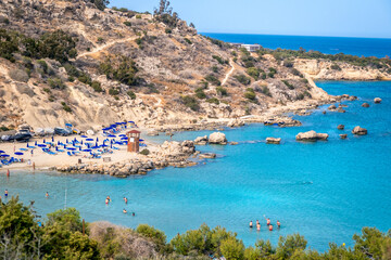 AYIA NAPA, CYPRUS - MAY 01, 2021 The beautiful beach Konnos Bay with turquoise water and tourists who swim and sunbathe