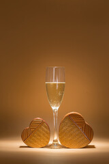 glass of cava and heart-shaped boxes in an intimate setting