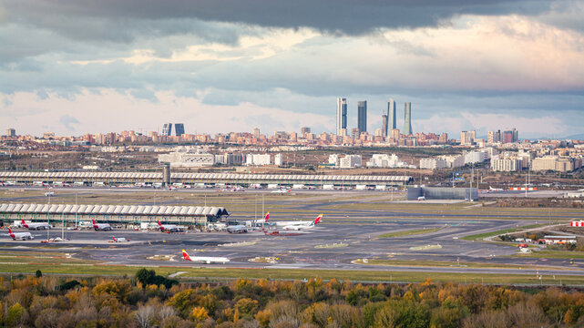 Madrid, Spain; 11/23/2019: Sunrise at the airport Adolfo Suarez Madrid Barajas overlooking the city skyline and the "four towers" with a cloudy sky