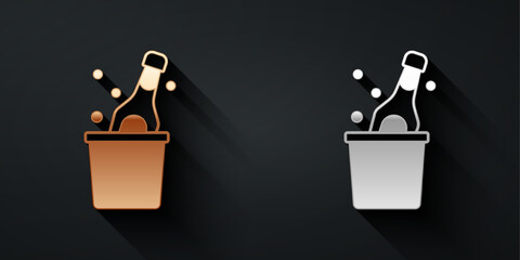 Gold and silver Bottle of champagne in an ice bucket icon isolated on black background. Long shadow style. Vector