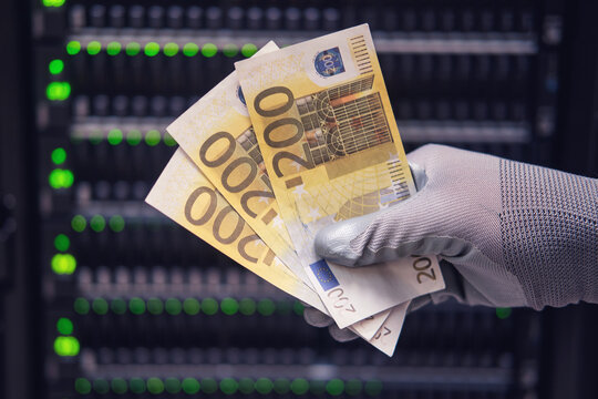 Money euros in the hands of a man on the background of a data storage server, close-up