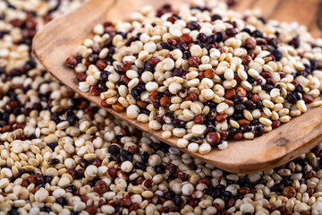 Red, white and brown quinoa seeds background, macro closeup