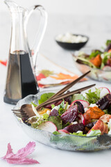 Roasted beet and carrot salad topped with feta and balsamic dressing.