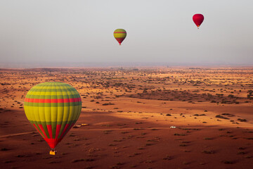 hot air balloon flying over the Moroccan desert and the atlas mountains