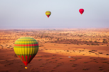 hot air balloon flying over the Moroccan desert and the atlas mountains