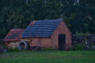 Fototapeta premium old dilapidated brick shed in the countryside