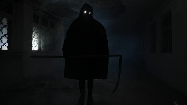 death with scythe standing in the dark hall. Horror silhouette inside ruined building