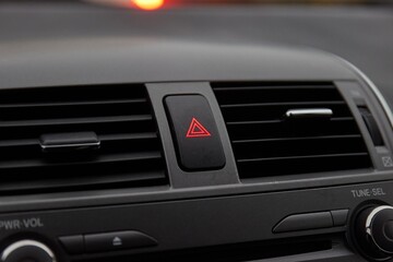 Fototapeta na wymiar Dashboard hazard light button in stopping traffic