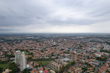 Fototapeta na wymiar Aerial photography of the city of Piracicaba. Rua do Porto, recreation parks, cars, lots of vegetation and the Piracicaba river crossing the city.