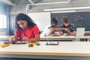 Group of students learning electronics and robotics at High School College