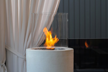 Burning eco bio round fireplace close-up
