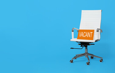 White office chair with sign VACANT on light blue background, space for text