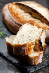 Fresh baked crunchy durum rosemary bread with a decorative score.