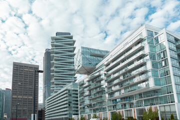 modern glass architecture buildings with Tower at Pier 27 building. Residential condos with crooked balconies and exterior of office buildings