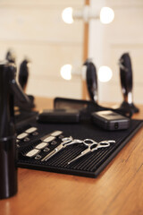 Stylish hairdresser's workplace with professional tools in barbershop, closeup