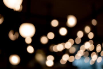 abstract blurred background of lights. Abstract blurry dark indoor plaza hall with a lot of small...
