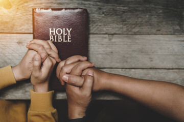 Top view christian of couple or group people holding hands praying worship together to believe and...