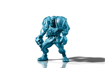 Figurine of an aggressive and vicious bald warrior in armor with a skull isolated on a white background with reflection and shadow added