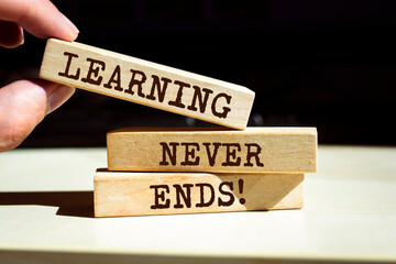 Wooden blocks with words 'Learning Never Ends'.