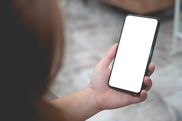 Close up women using a smartphone with an empty white screen at home.